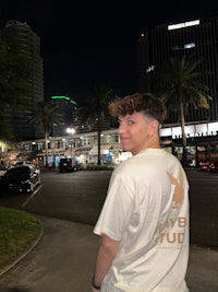 a man standing on a sidewalk at night